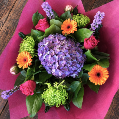 Vibrant Delight - A vibrant mixture of flowers including lime blooms, Germini, Roses and Liatris, perfect for cheering someone up.