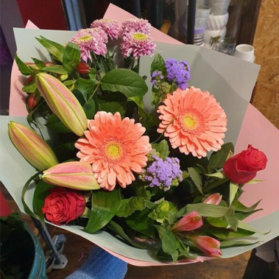Peach Perfect - A charming handtied in water presented in a gift box, created using the fresh blooms of the day in peach tones, red and purple with complementary foliage. Created by an expert florist at Lily Blossom Florist in Huddersfield and delivered with care.