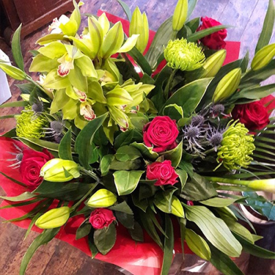 Head Over Heels - A beautiful luxurious hand tied bouquet delivered in water and presented in a gift box, created using the freshest blooms of the day. This bouquet screams romance, using beautiful scented lilies, roses, blue thistles and cymbidium orchids which will feel like they last forever. Luxury never looked so good. The colour theme and the flowers all created by an expert florist at Lily Blossom Florist in Huddersfield and delivered with care. This bouquet is a must for Valentine's, Anniversaries, or just to simply say I love you. We always recommend taking the flowers out of their wrapping as soon as possible and placing them into a fresh, clean vase of water. Why not purchase a vase alongside and let us deliver them all ready cut and made up into a vase. More time for thank you smooches!